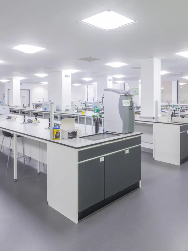 Empty laboratory with grey flooring and white lab space