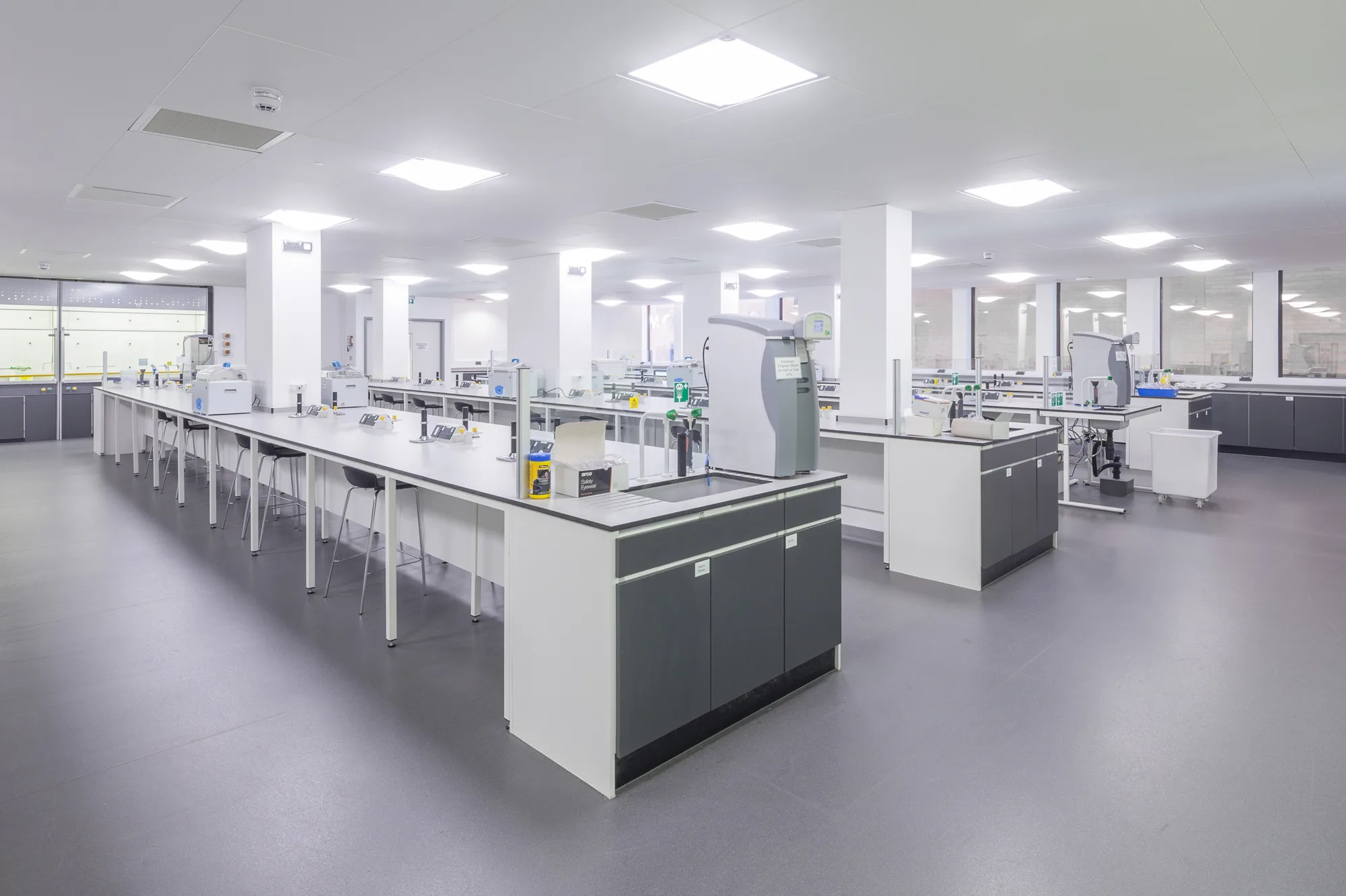 Empty laboratory with grey flooring and white lab space
