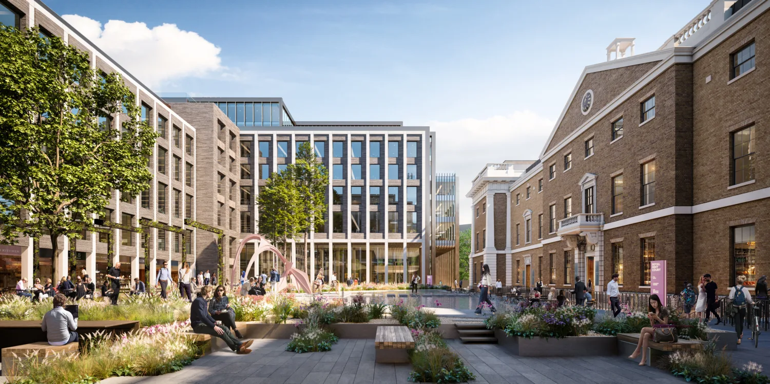 An open courtyard, featuring wooden benches, potted plants and a pond, surrounded by modern and historic buildings converted into offices