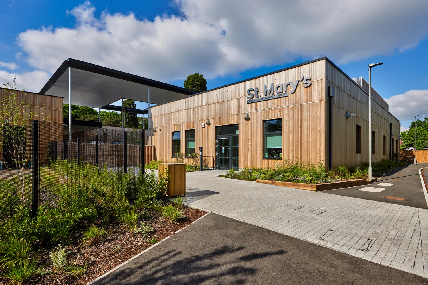 Exterior of St Marys Voluntary Catholic school surrounded by greenery