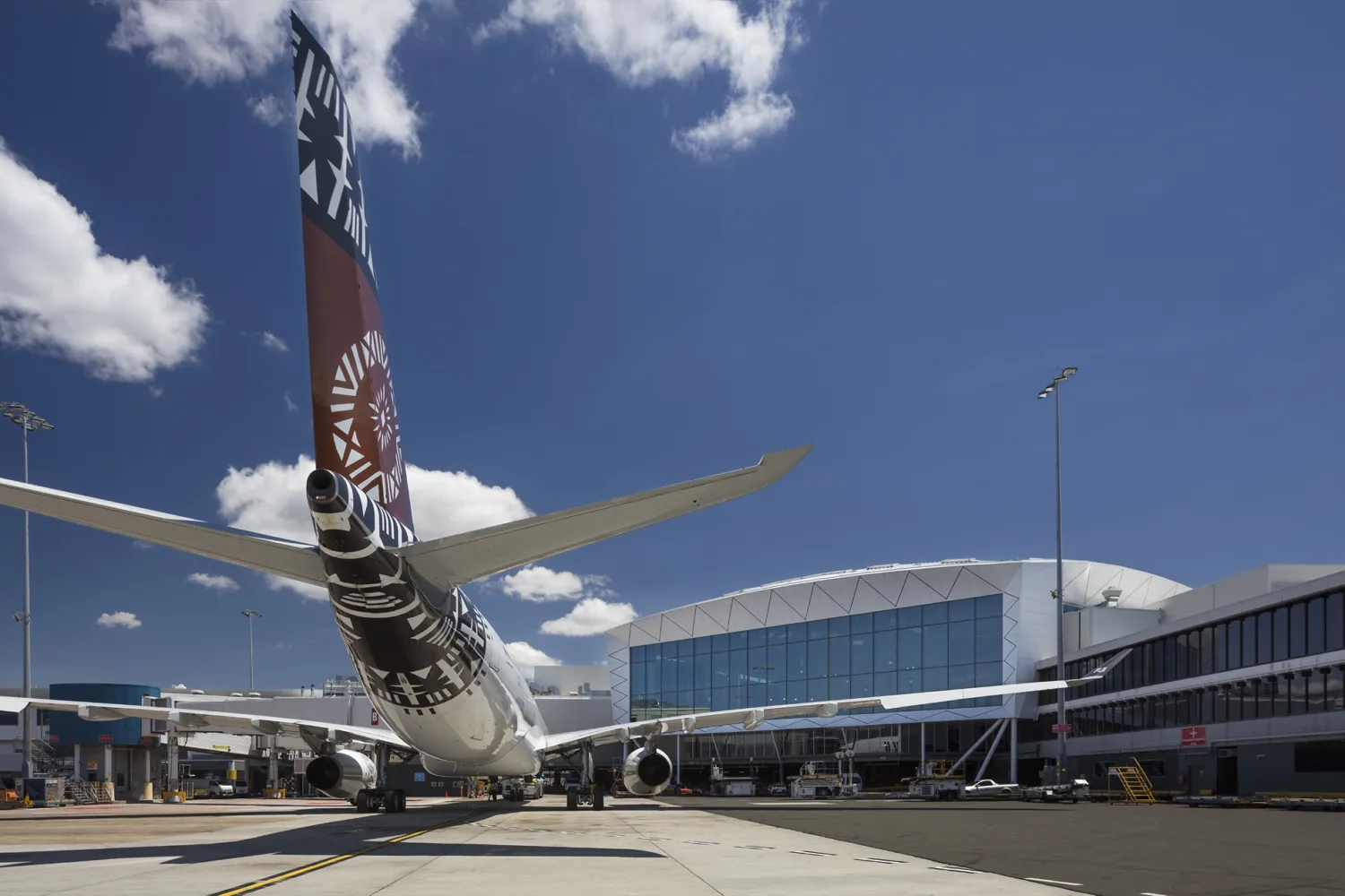 Terminal building from tarmac with the rear of a plane in view