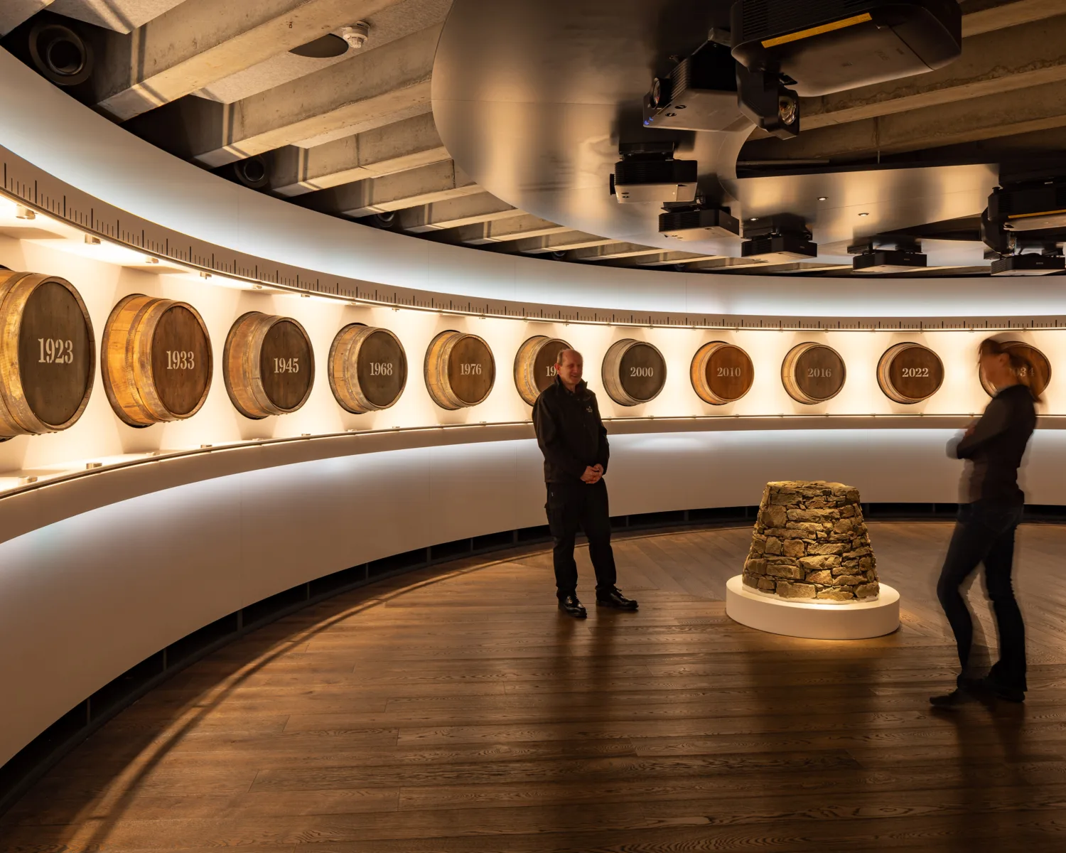 Internal view with whiskey barrels lining wall