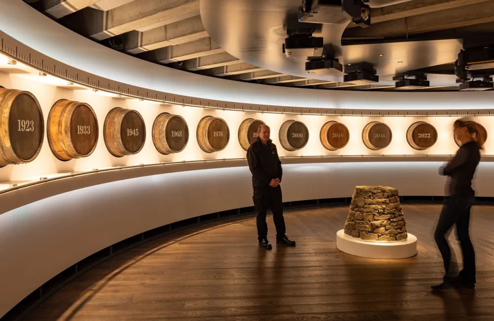 Internal view with whiskey barrels lining wall