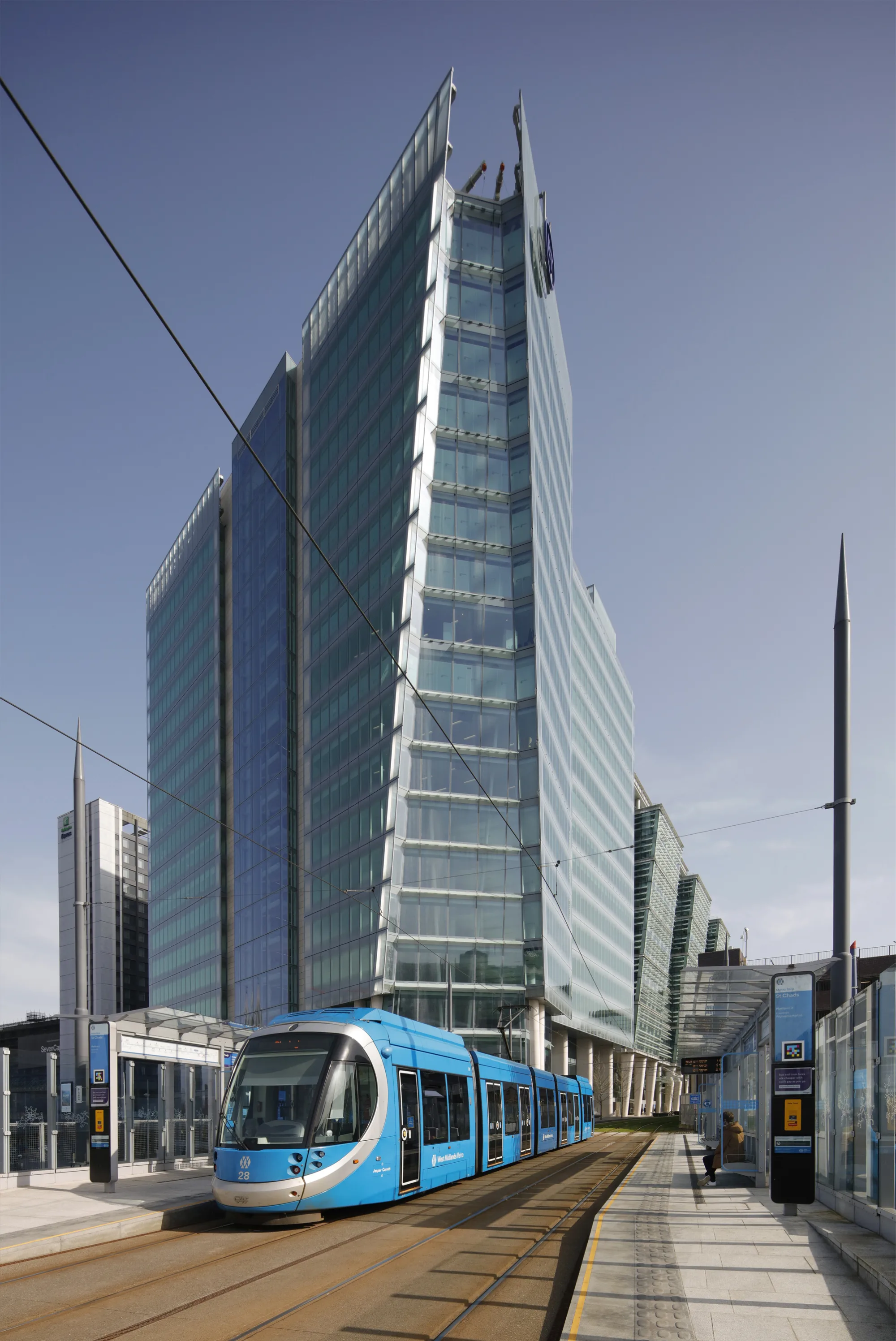Exterior of Three Snowhill with tram and a tram station in the foreground