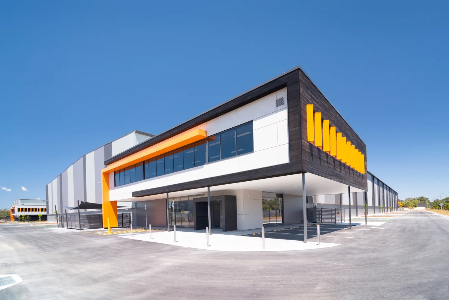 Office and distribution centre building, surrounding area and blue sky in background