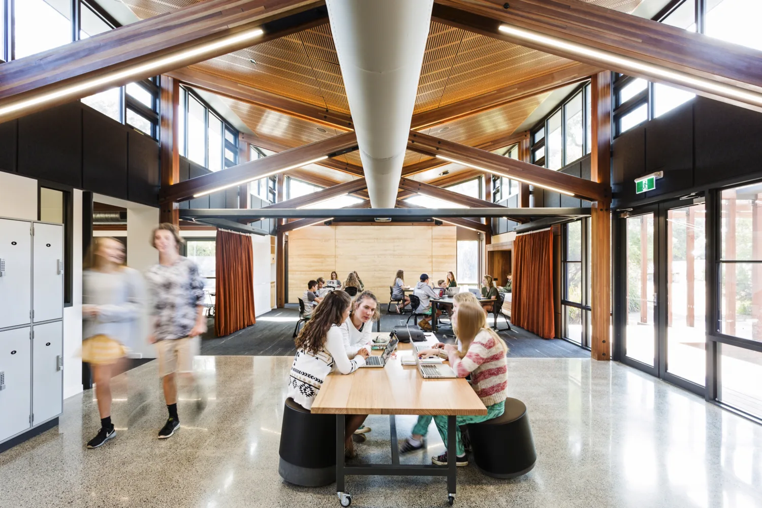 Interior image of Woodleigh School with students on computers and walking using the facility