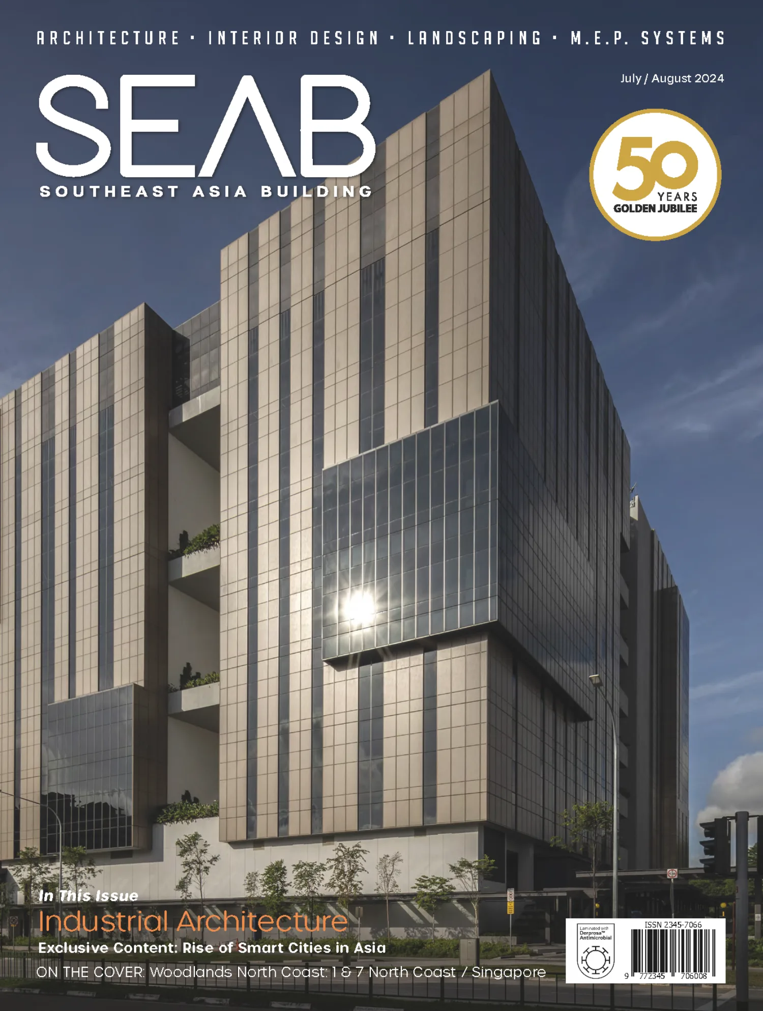 Front cover of magazine, modern building with glass windows and surrounded by plants
