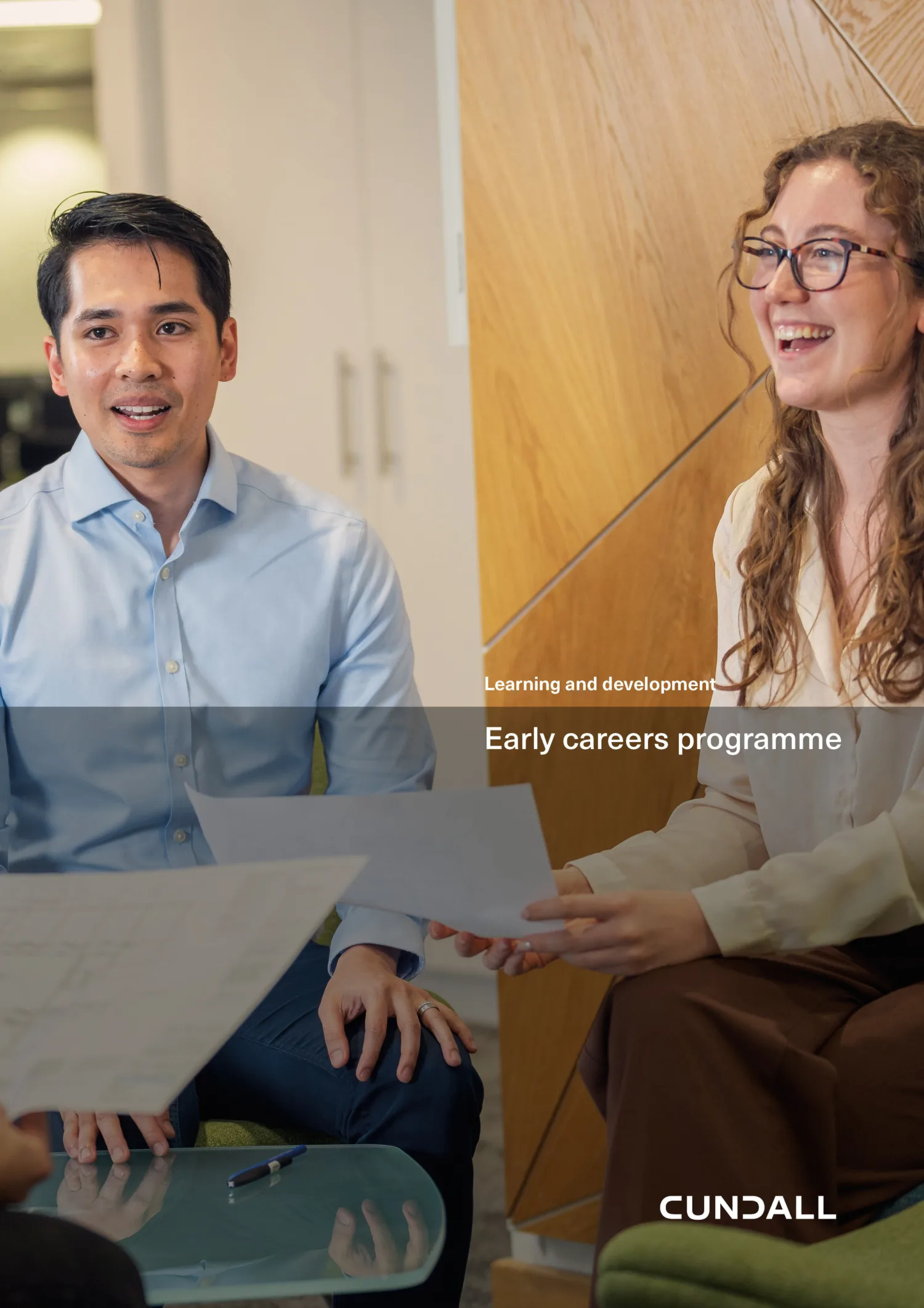 Male and Female graduates talking around a table