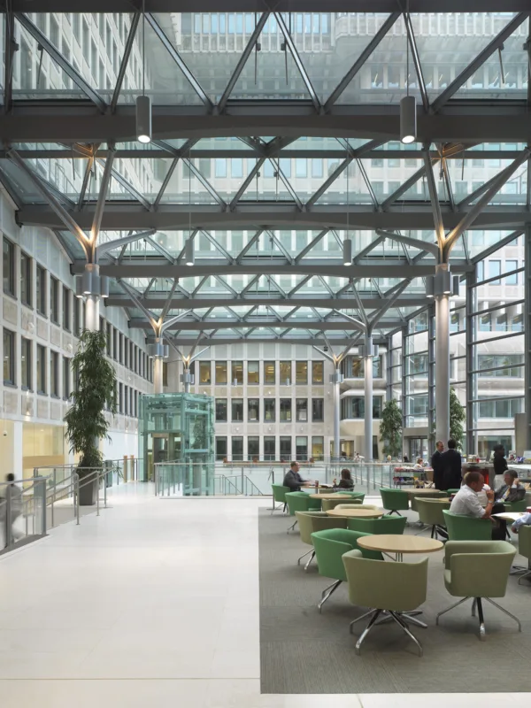 Office foyer interior with a glass façade and reception tables at 50 Queen Annes Gate in London