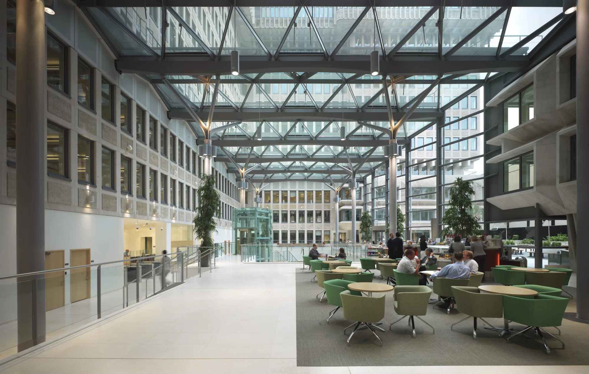 Office foyer interior with a glass façade and reception tables at 50 Queen Annes Gate in London