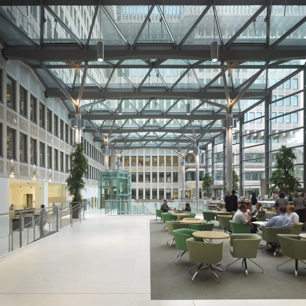 Office foyer interior with a glass façade and reception tables at 50 Queen Annes Gate in London