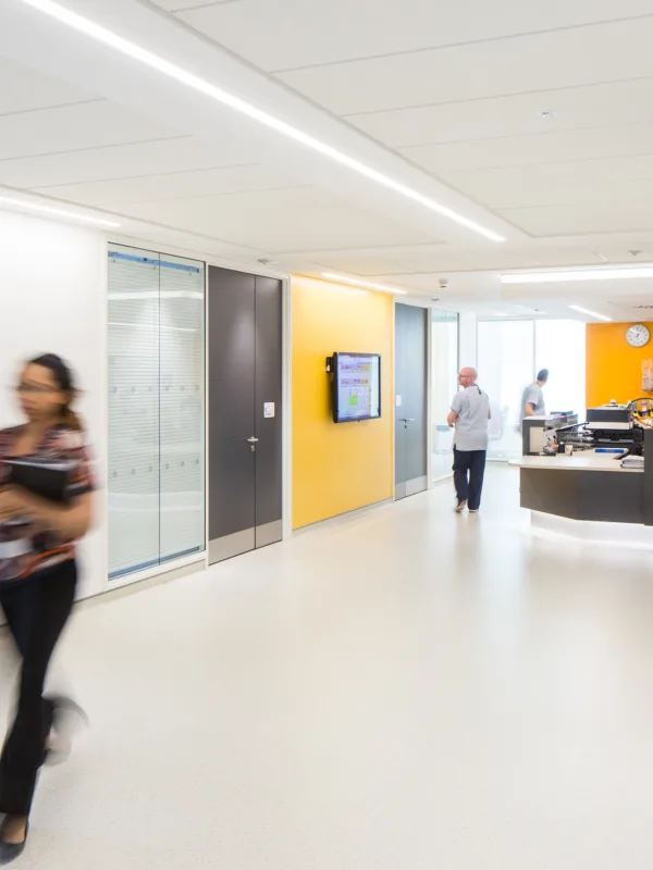 Reception desk, medical rooms and corridor with healthcare staff walking around Ulster Hospital