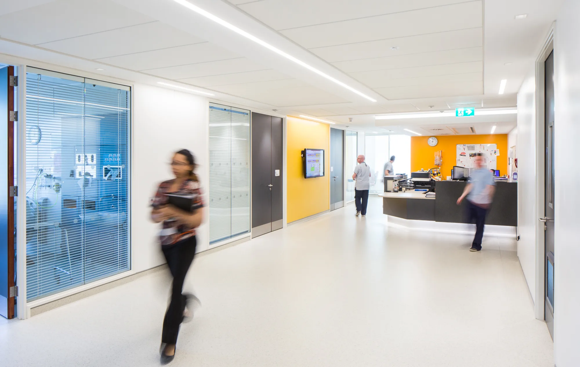 Reception desk, medical rooms and corridor with healthcare staff walking around Ulster Hospital