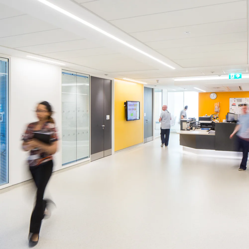 Reception desk, medical rooms and corridor with healthcare staff walking around Ulster Hospital