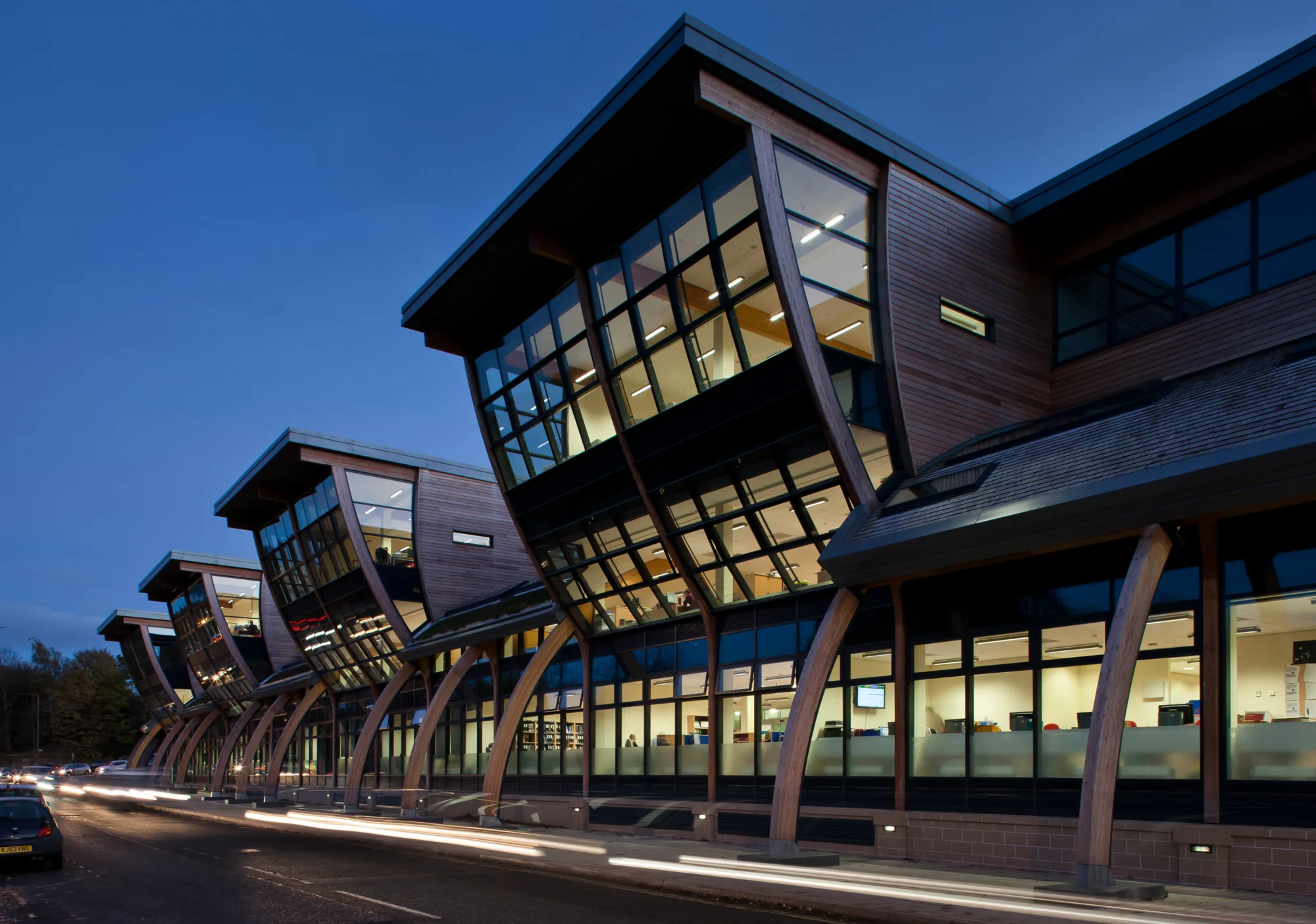 Evening shot of the exterior façade of glass and wood of the Palatine Centre, Durham University