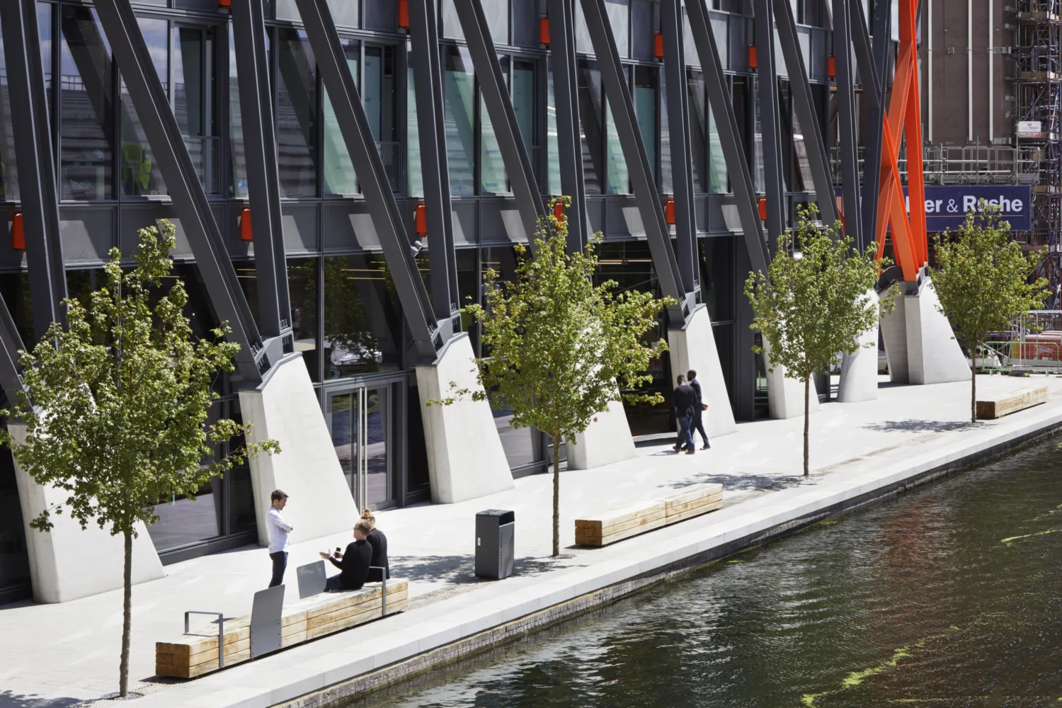 The Brunel Building façade of glass and steel next to a river