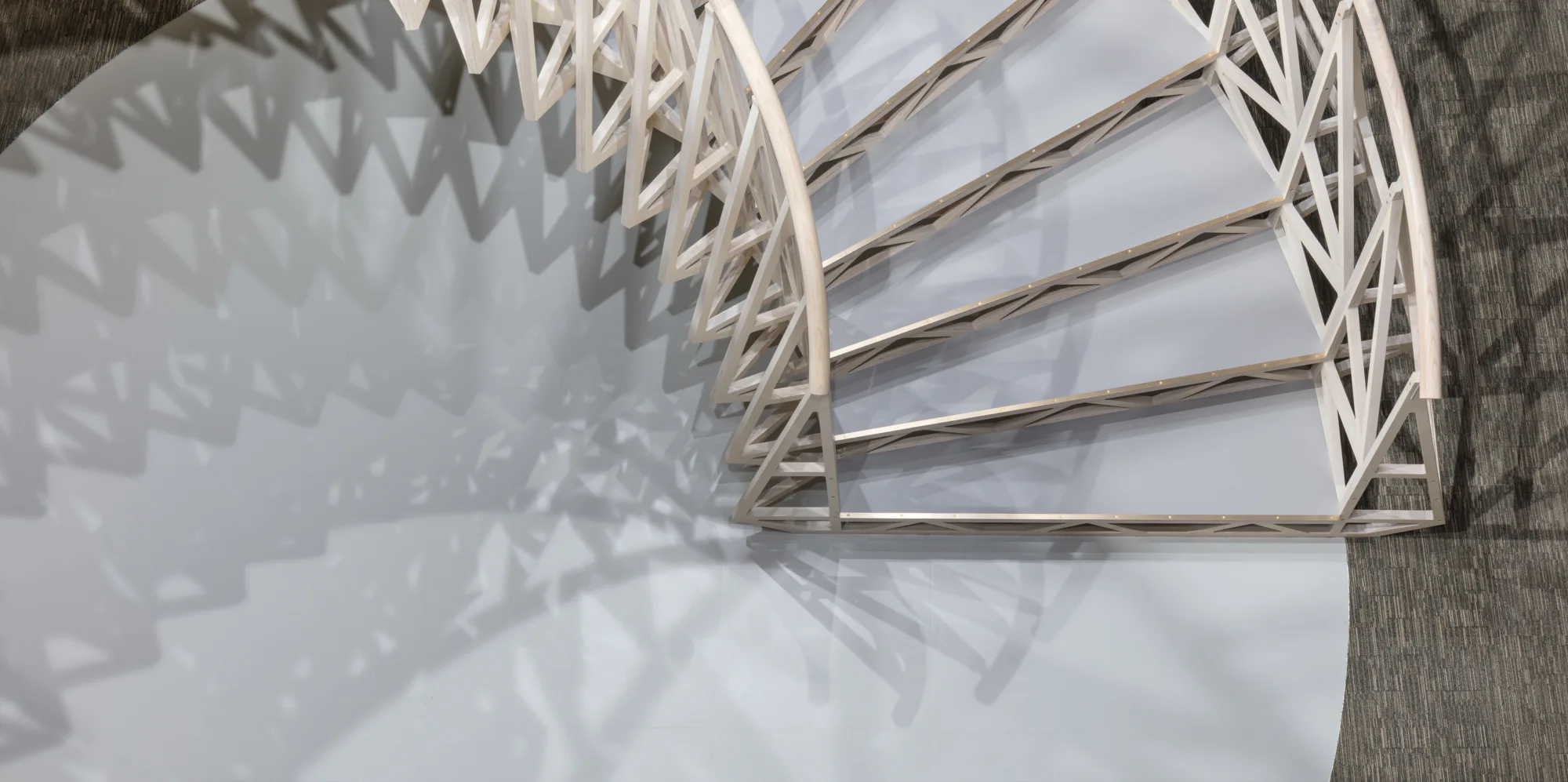 Overhead view of a white curved stairway