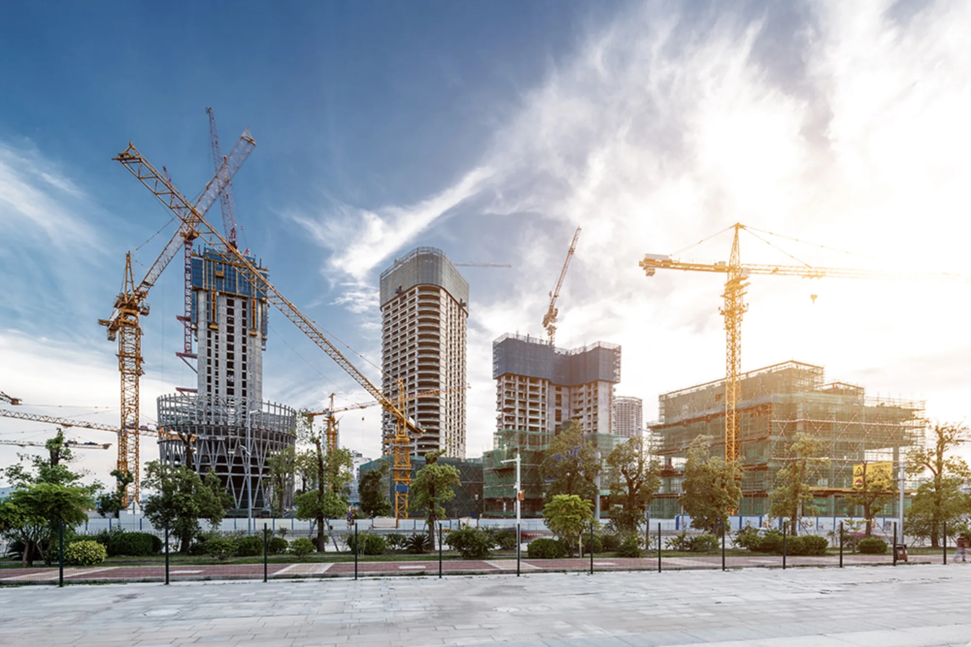 City construction site with yellow cranes and half built buildings