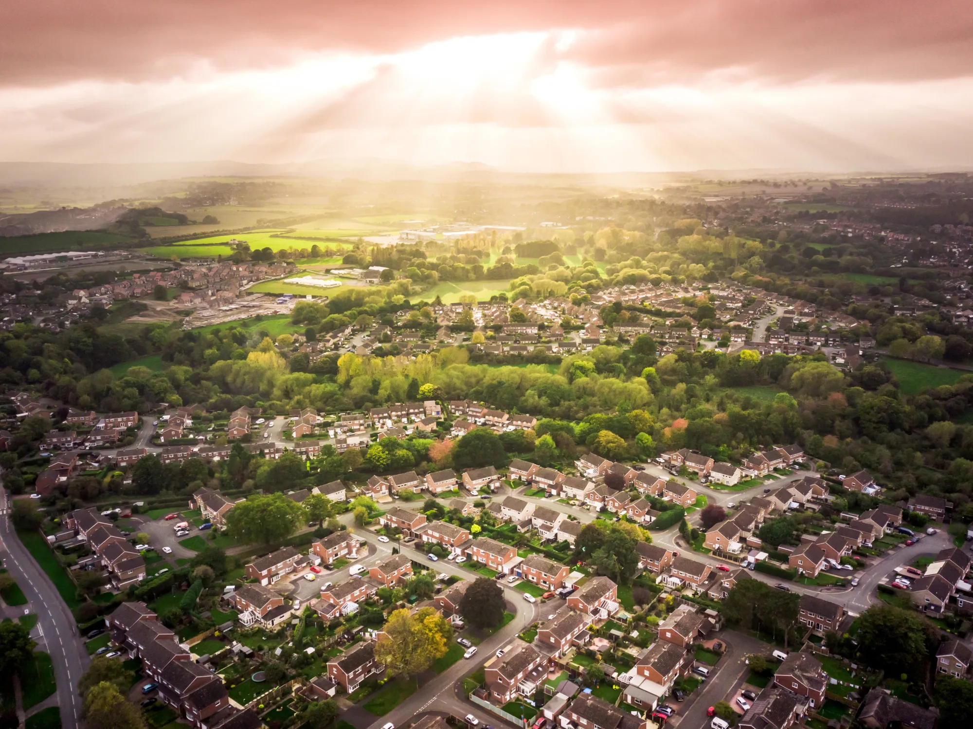 Aerial view of village with sun shinny through the clouds