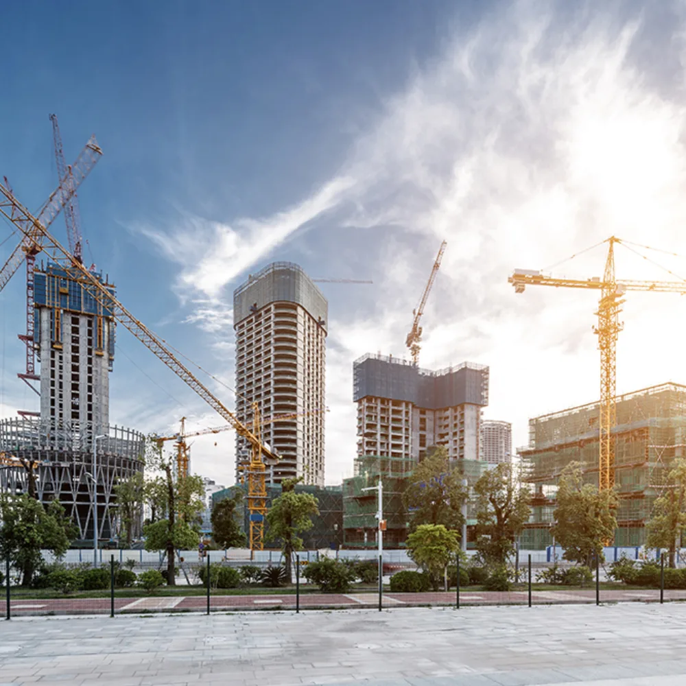 City construction site with yellow cranes and half built buildings