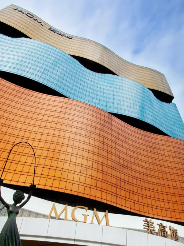 Looking up at the MGM Grand exterior with blue skies and a statue outside