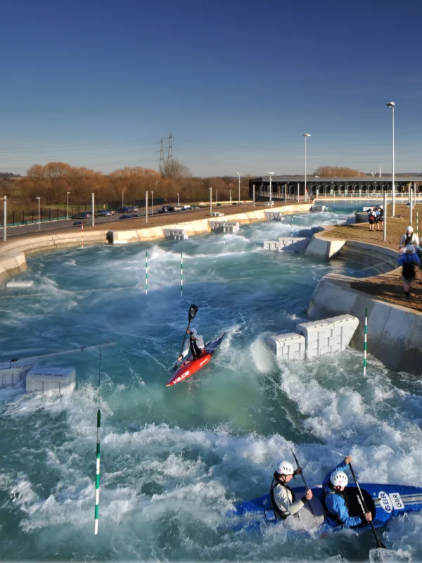 Broxbourne Lee Valley white water rafting centre with rapid waters and people in canoes