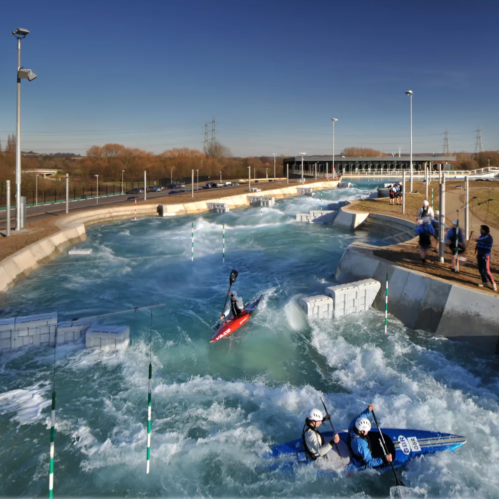 Broxbourne Lee Valley white water rafting centre with rapid waters and people in canoes