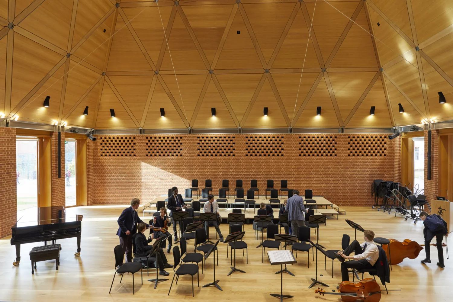 Wooden and brick interior of music room with student practicing music
