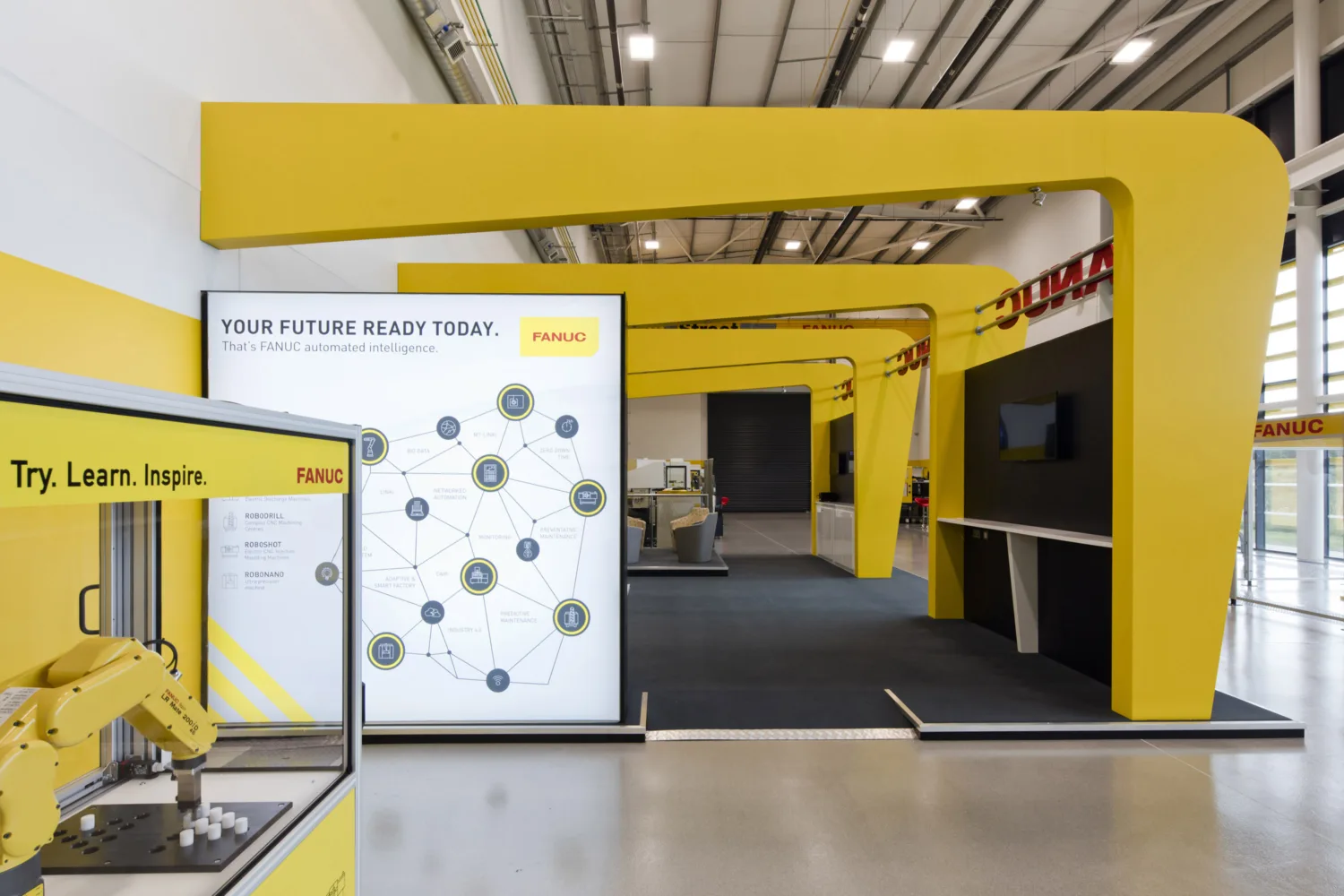 Manufacturing equipment in a foyer area of building with yellow detailing