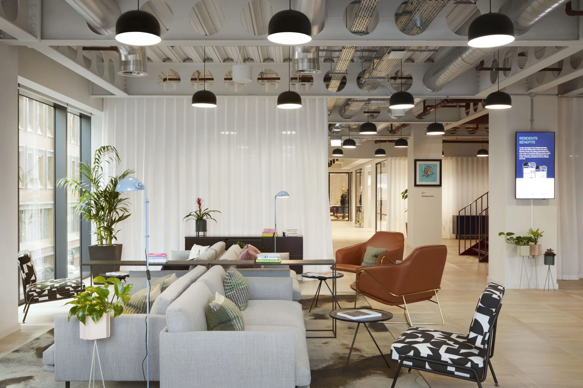 FORA (Reading) office interior with seating and hot desk space with planting