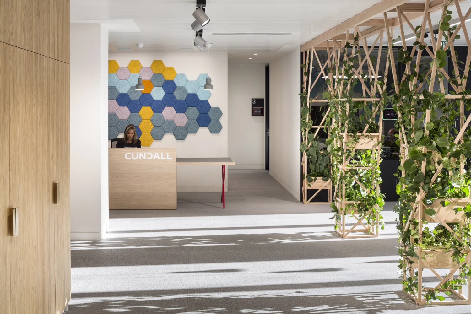 One Carter Lane reception office interior with meeting desk an planting