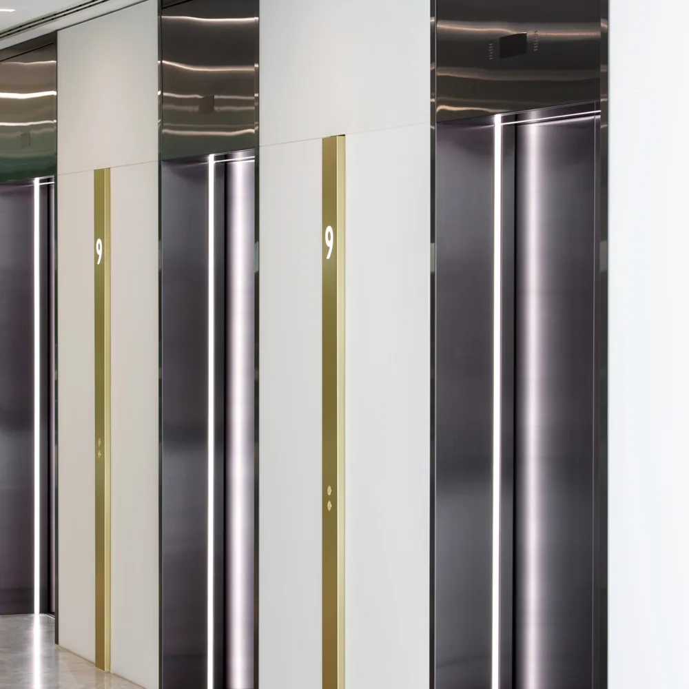 Broadgate Quarter lifts with lighting and gold bars