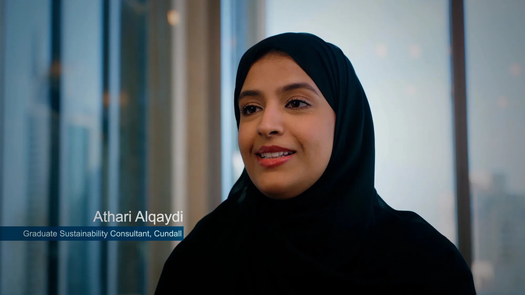 Athari Alqaydi smiling while being interviewed.