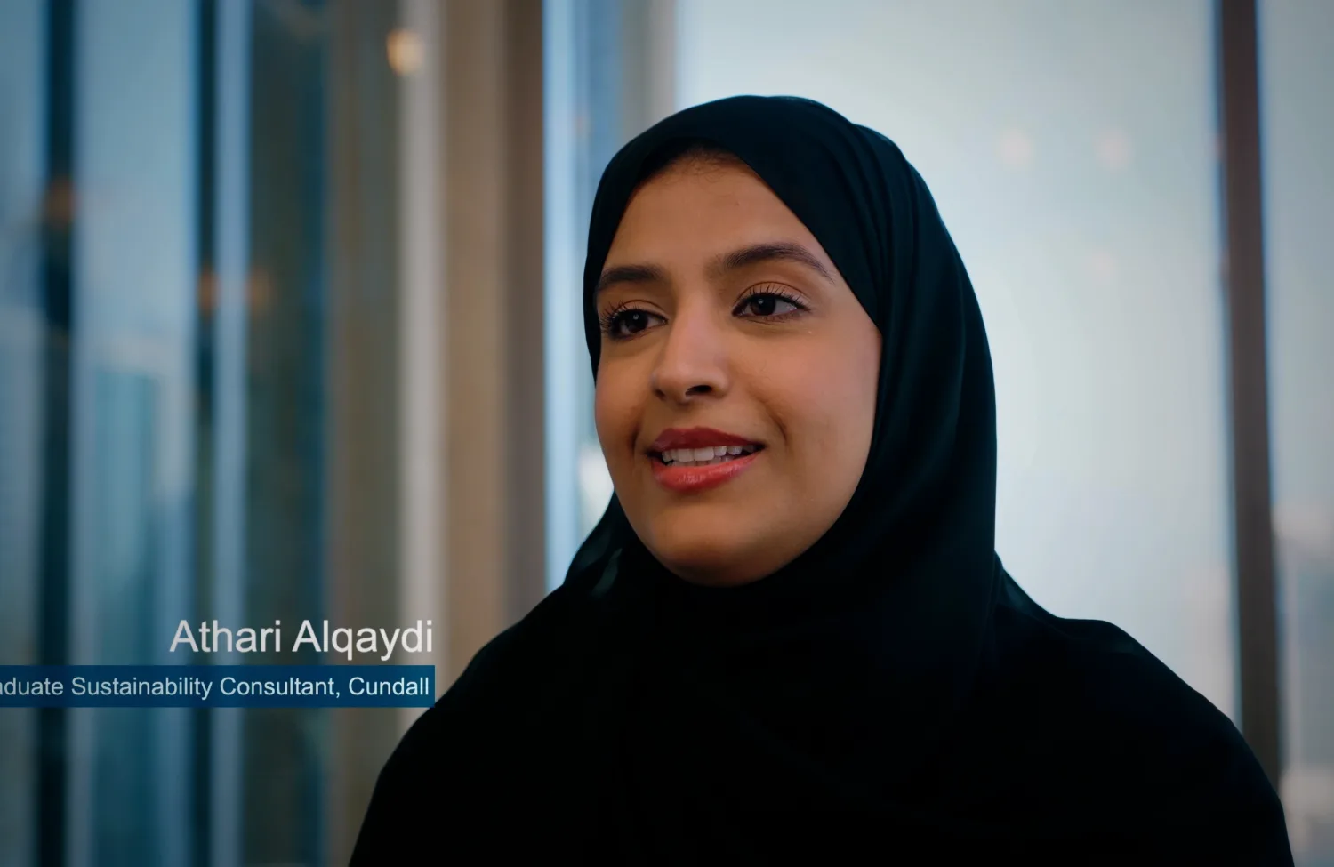 Athari Alqaydi smiling while being interviewed.