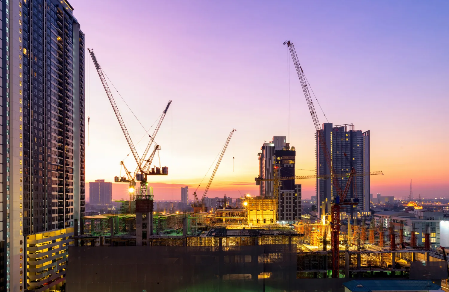 Building under construction against the purple sky