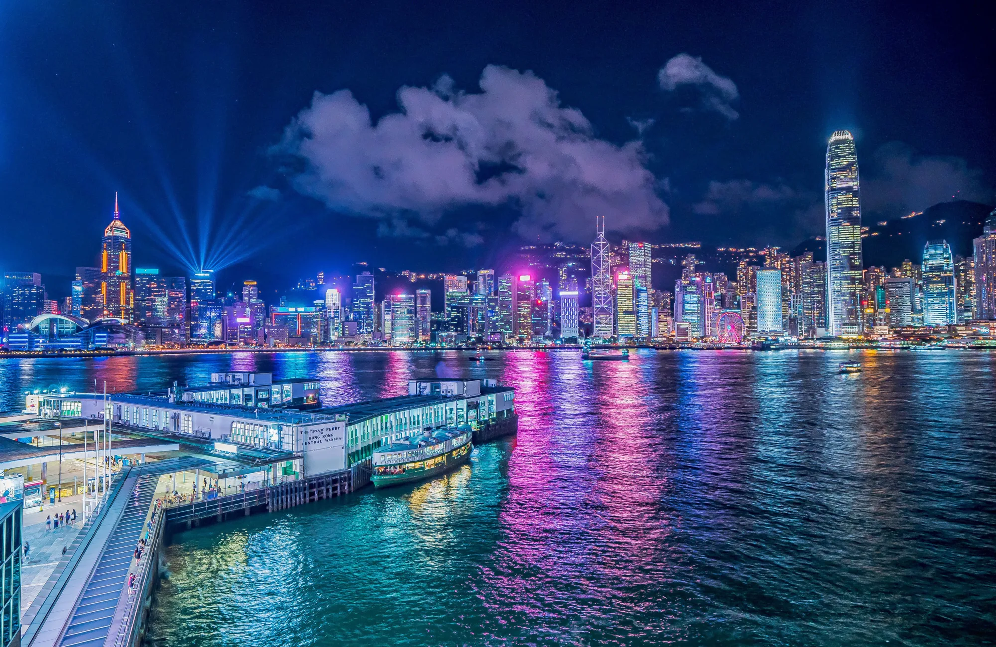 Night sky with brightly lit Hong Kong city skyline reflected in the water