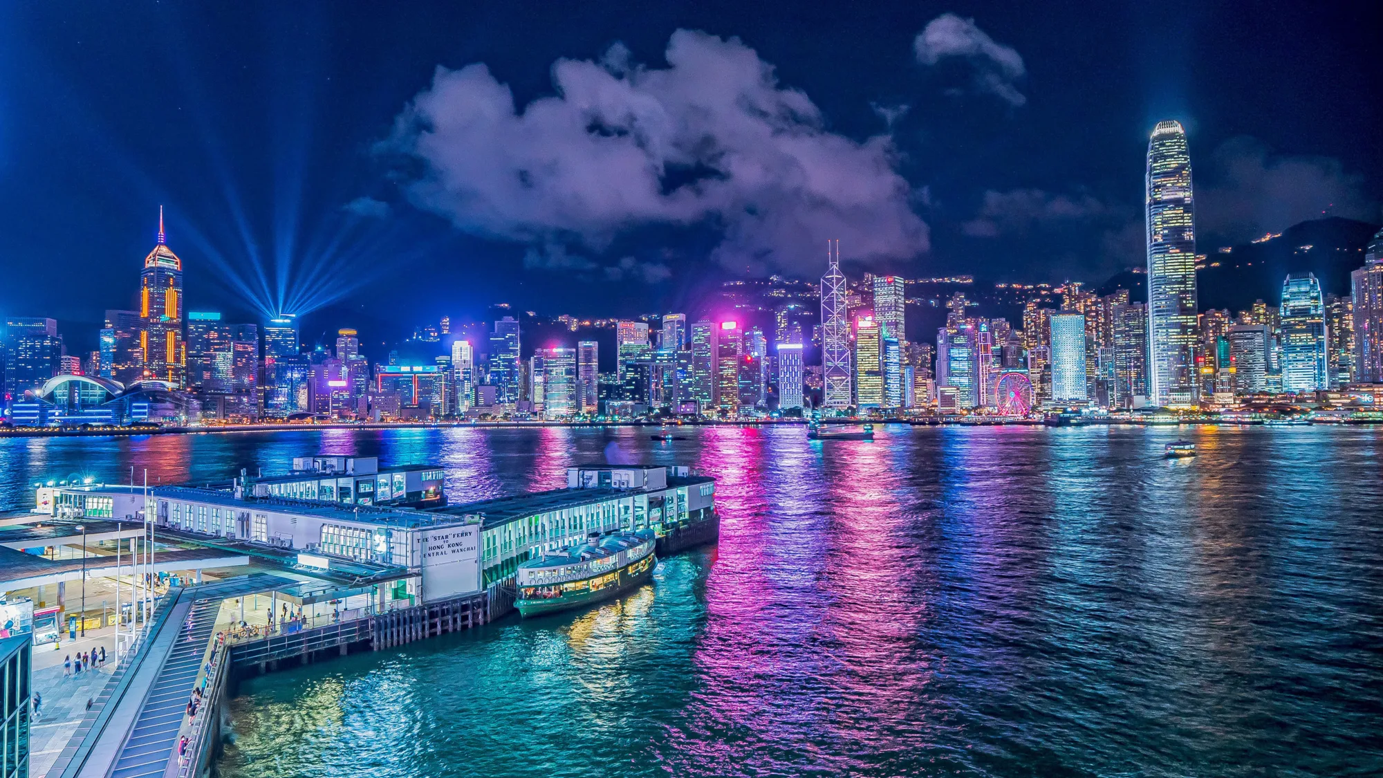 Night sky with brightly lit Hong Kong city skyline reflected in the water