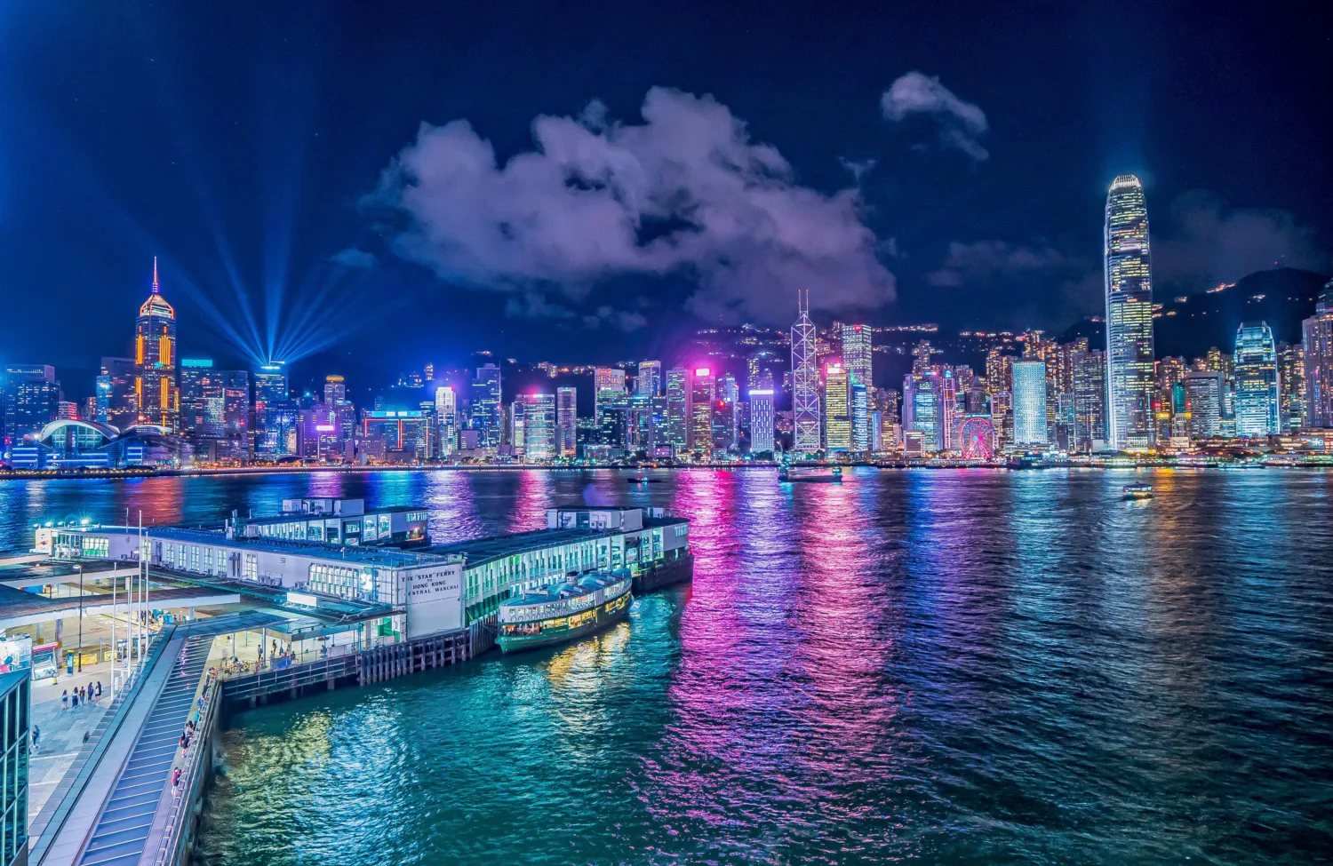 Night sky with brightly lit Hong Kong city skyline reflected in the water
