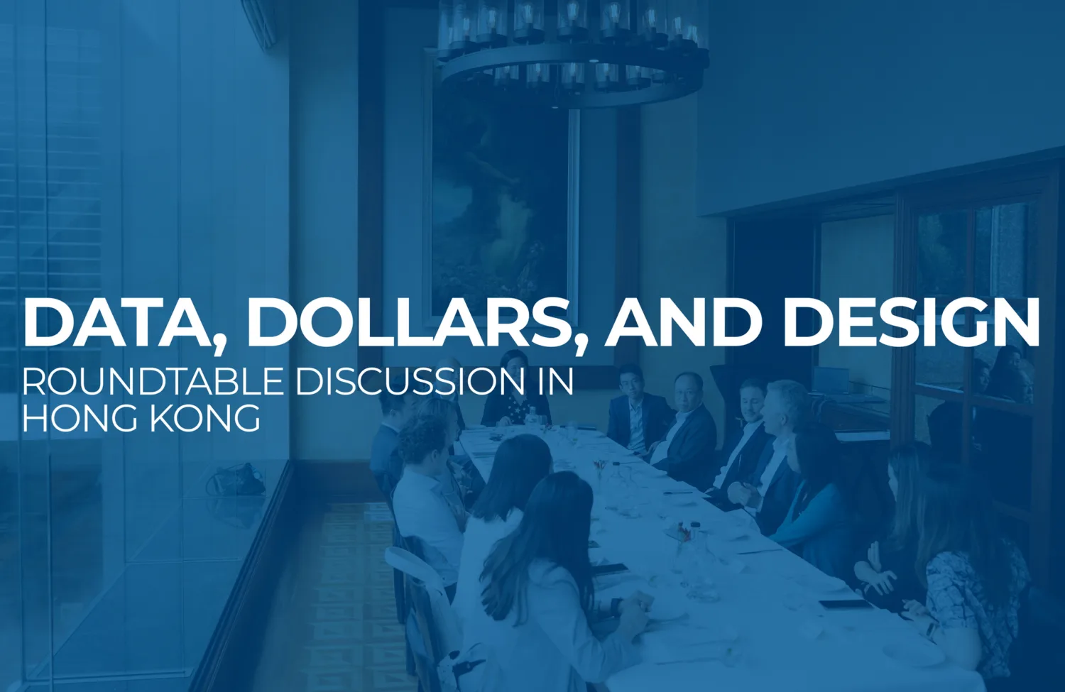 Blue overlay and title text with the video participants sat around a long oval table