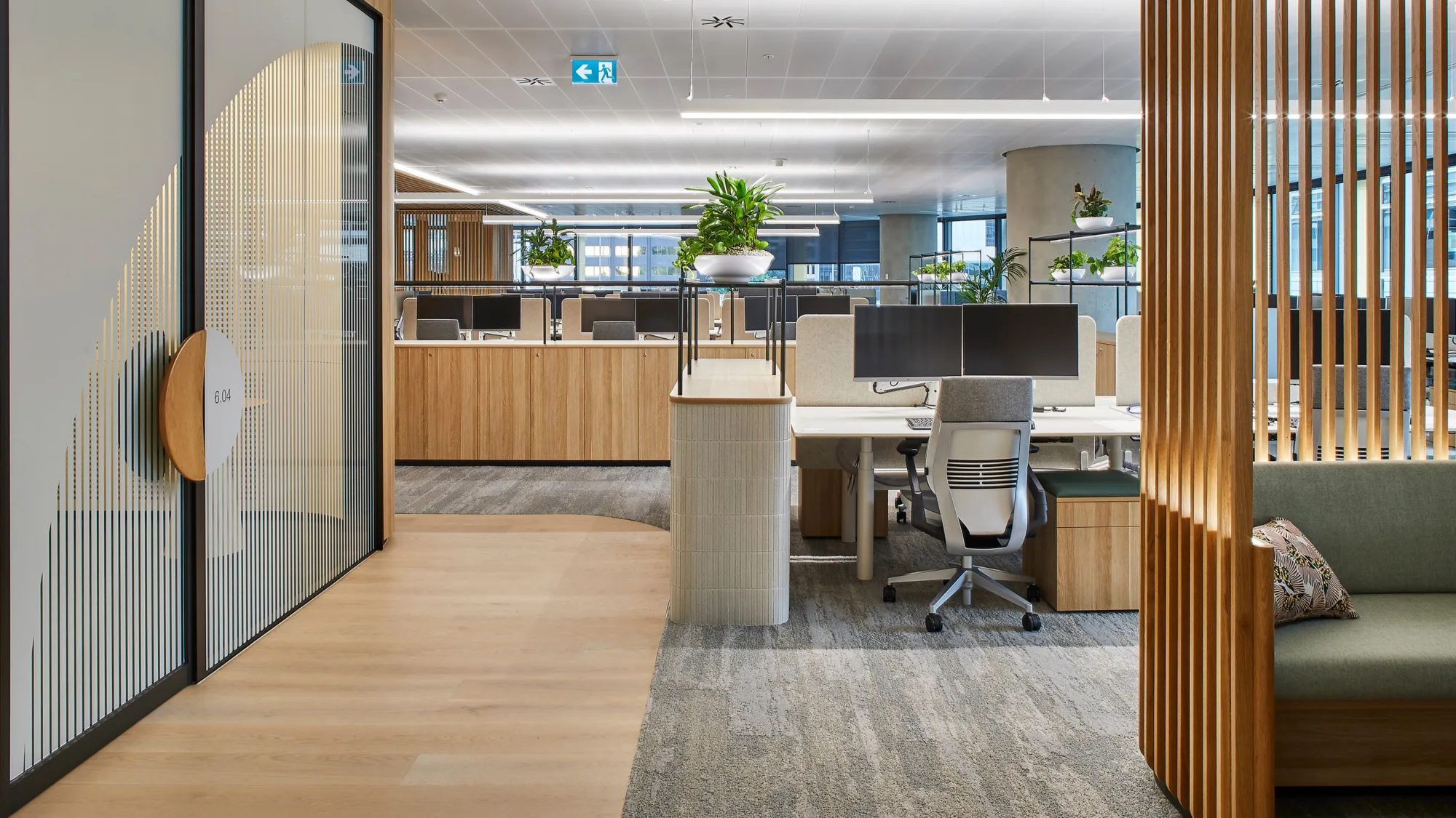 Empty lit and furnished office space with plants