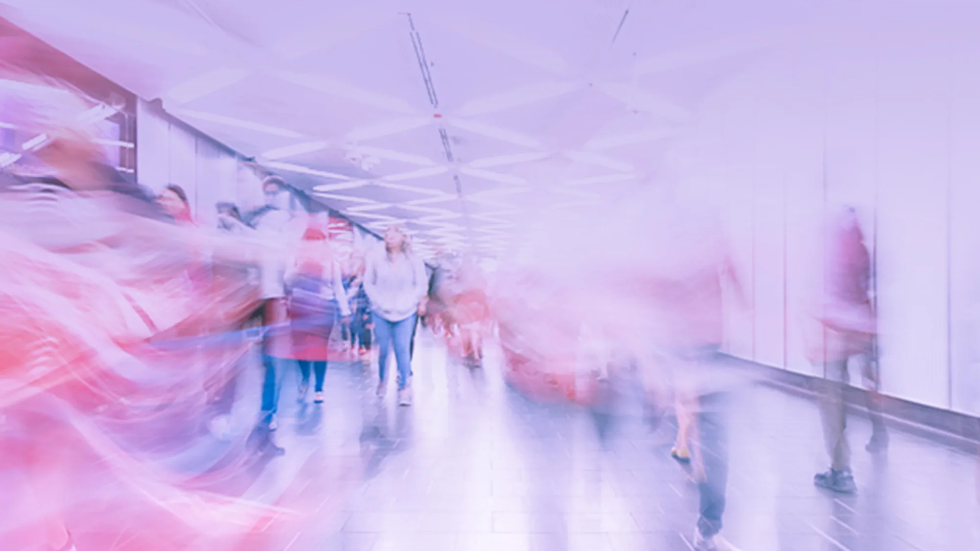 A long exposure image of people walking in a corridor