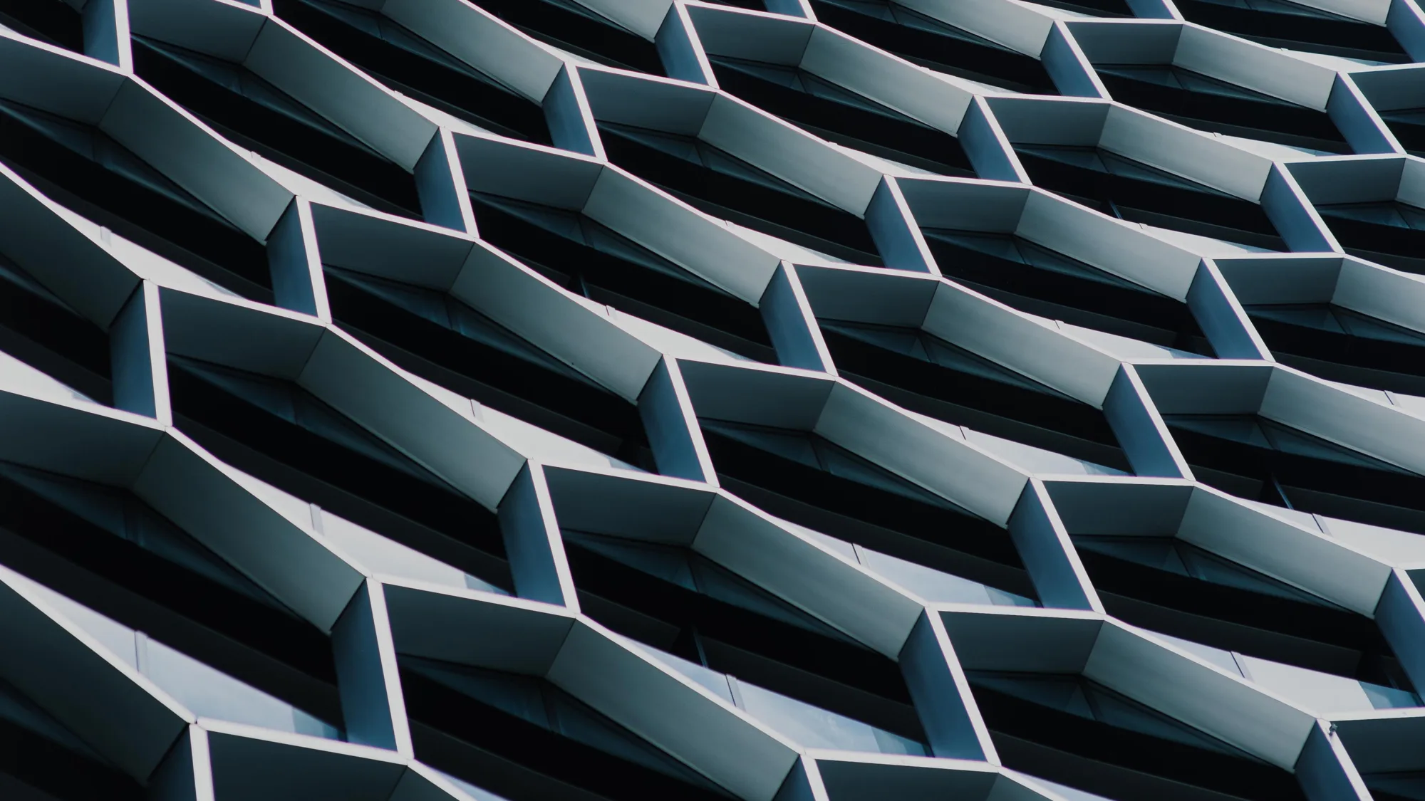 Honeycomb shaped exterior of a building with metal and glass panels