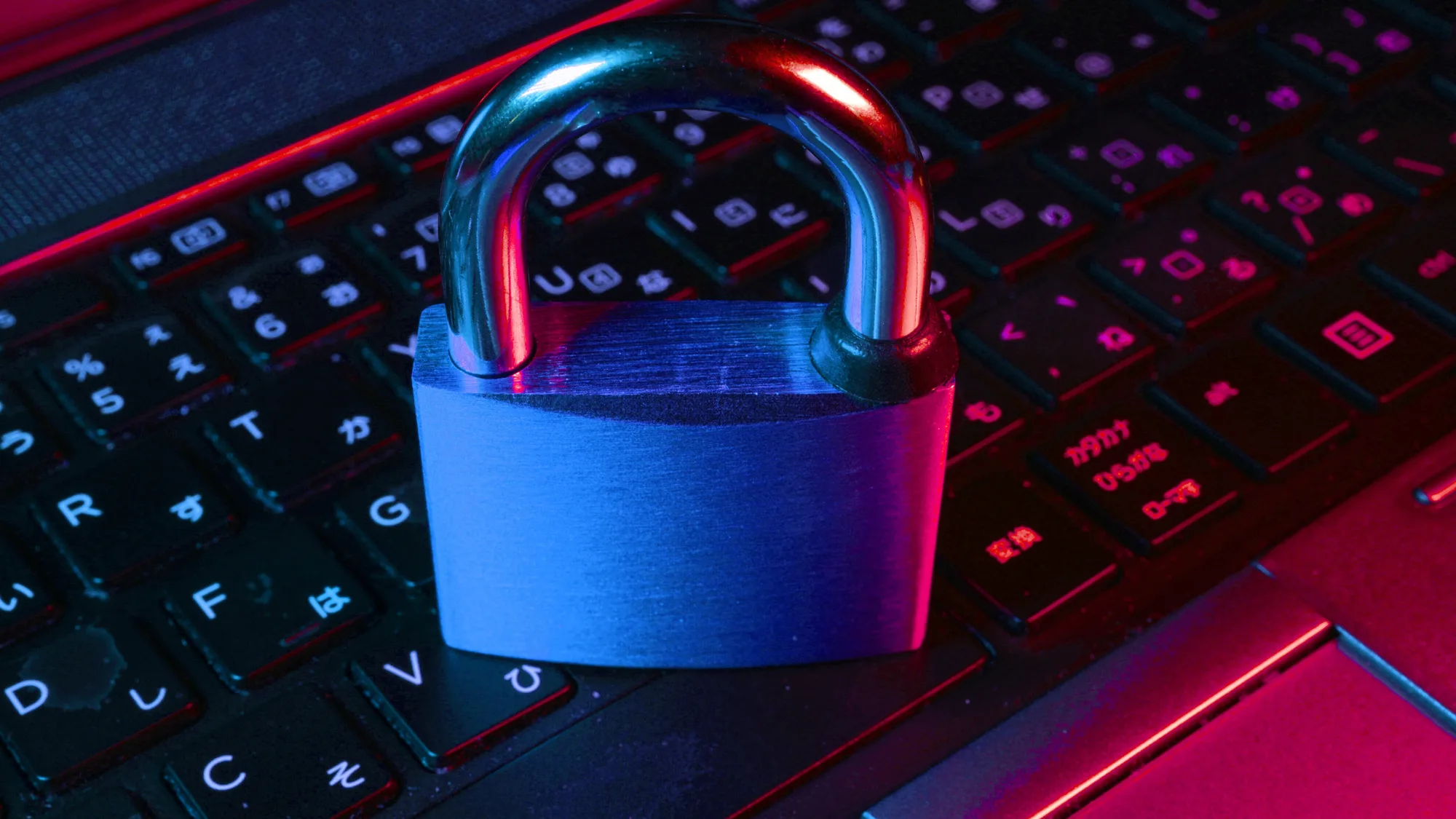 Padlock sitting on top of a laptops keyboard