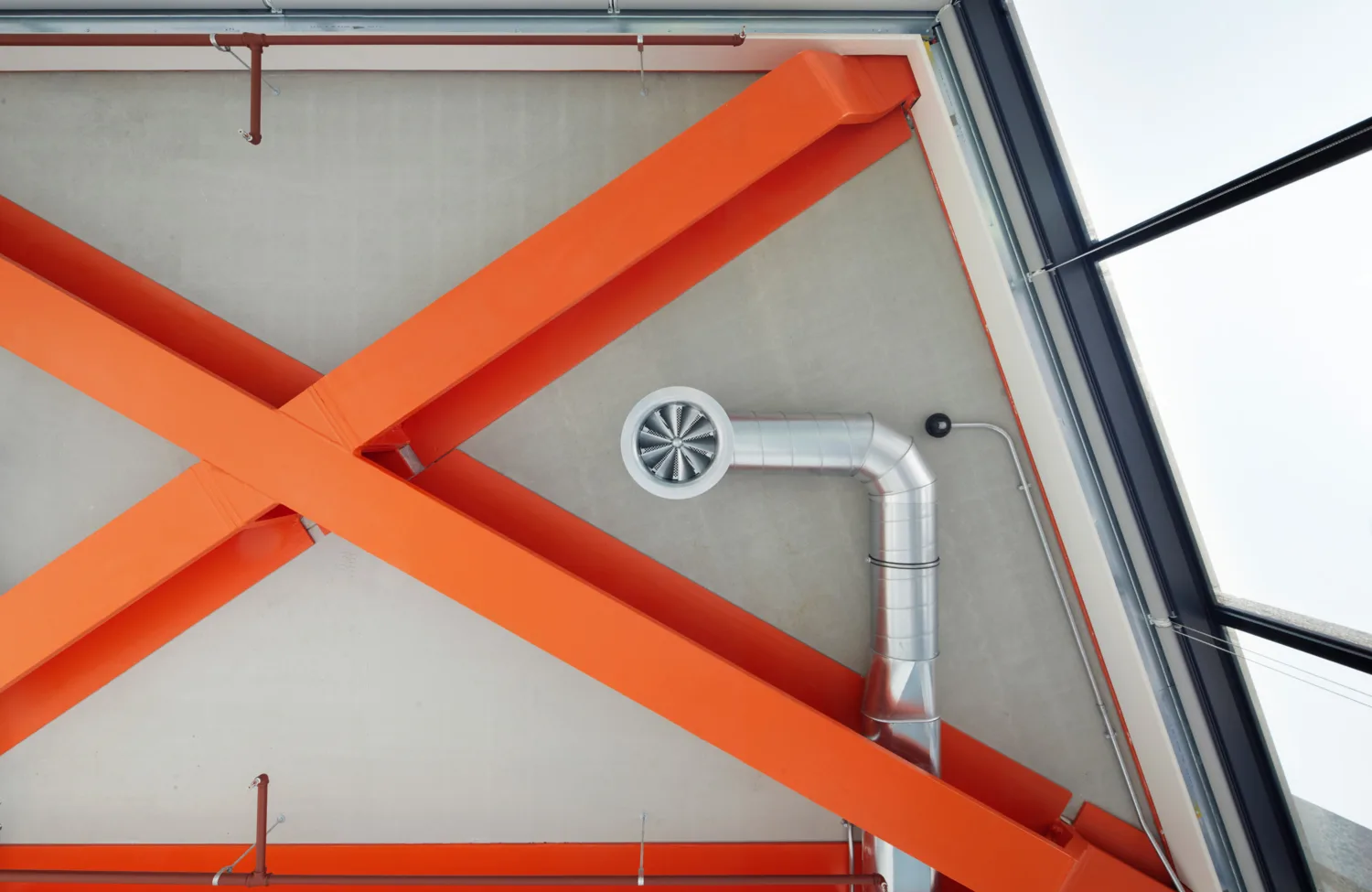 Ceiling of the Brunel Building showing orange beams and ventilation details