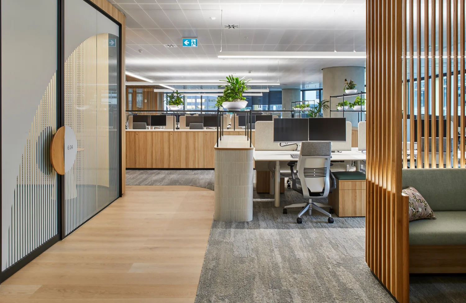 Empty lit and furnished office space with plants