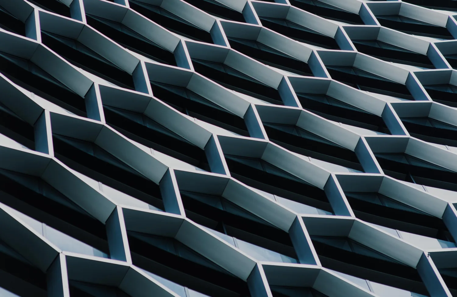 Honeycomb shaped exterior of a building with metal and glass panels