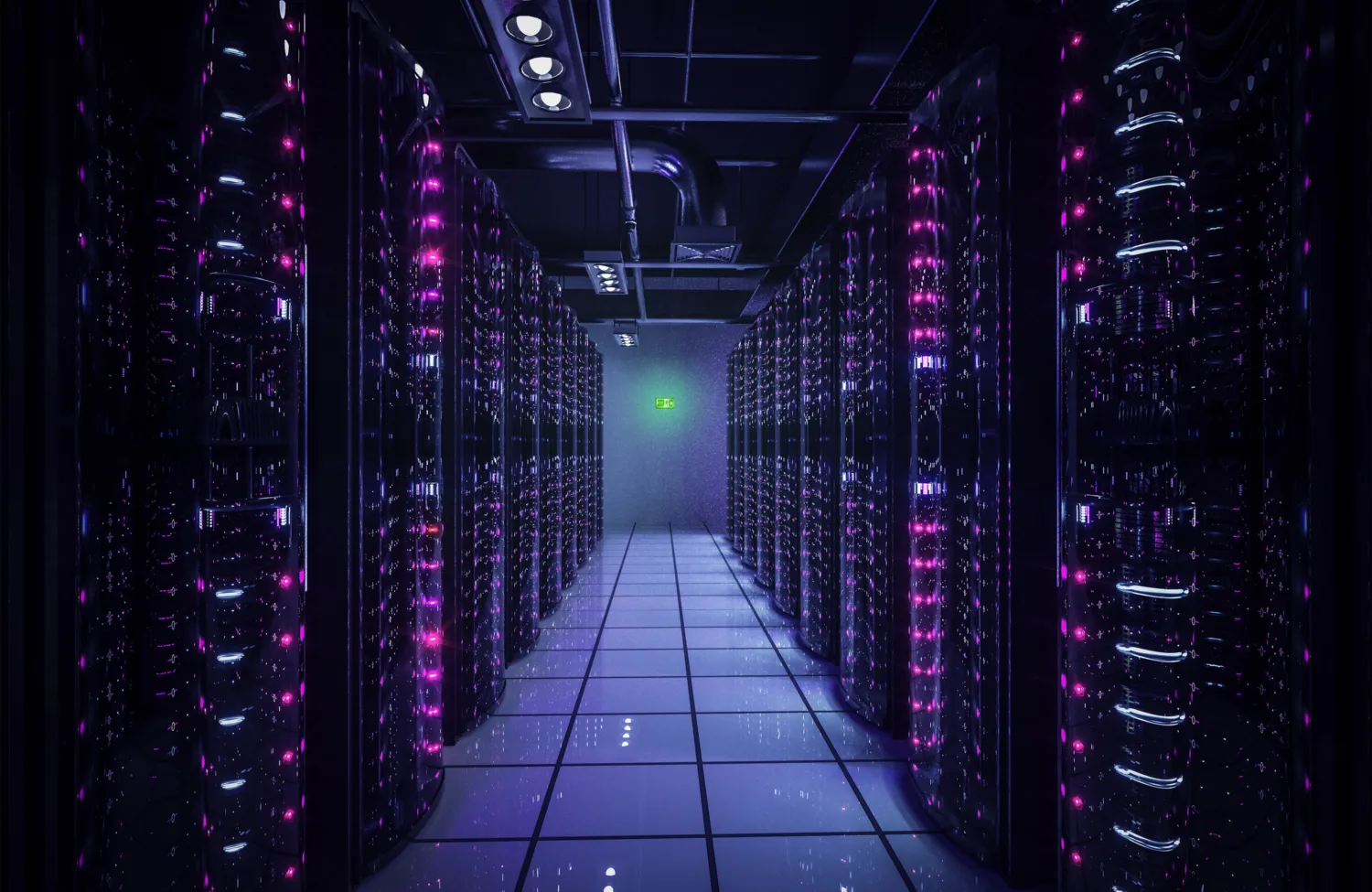 Long corridor of servers lit with pale blue and pink lights with an illuminated exit sign on the back wall