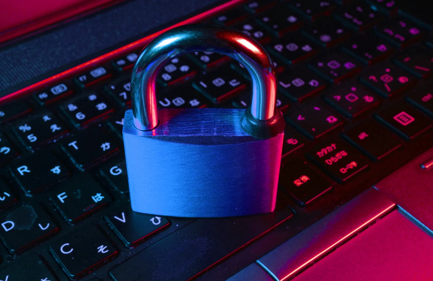 Padlock sitting on top of a laptops keyboard