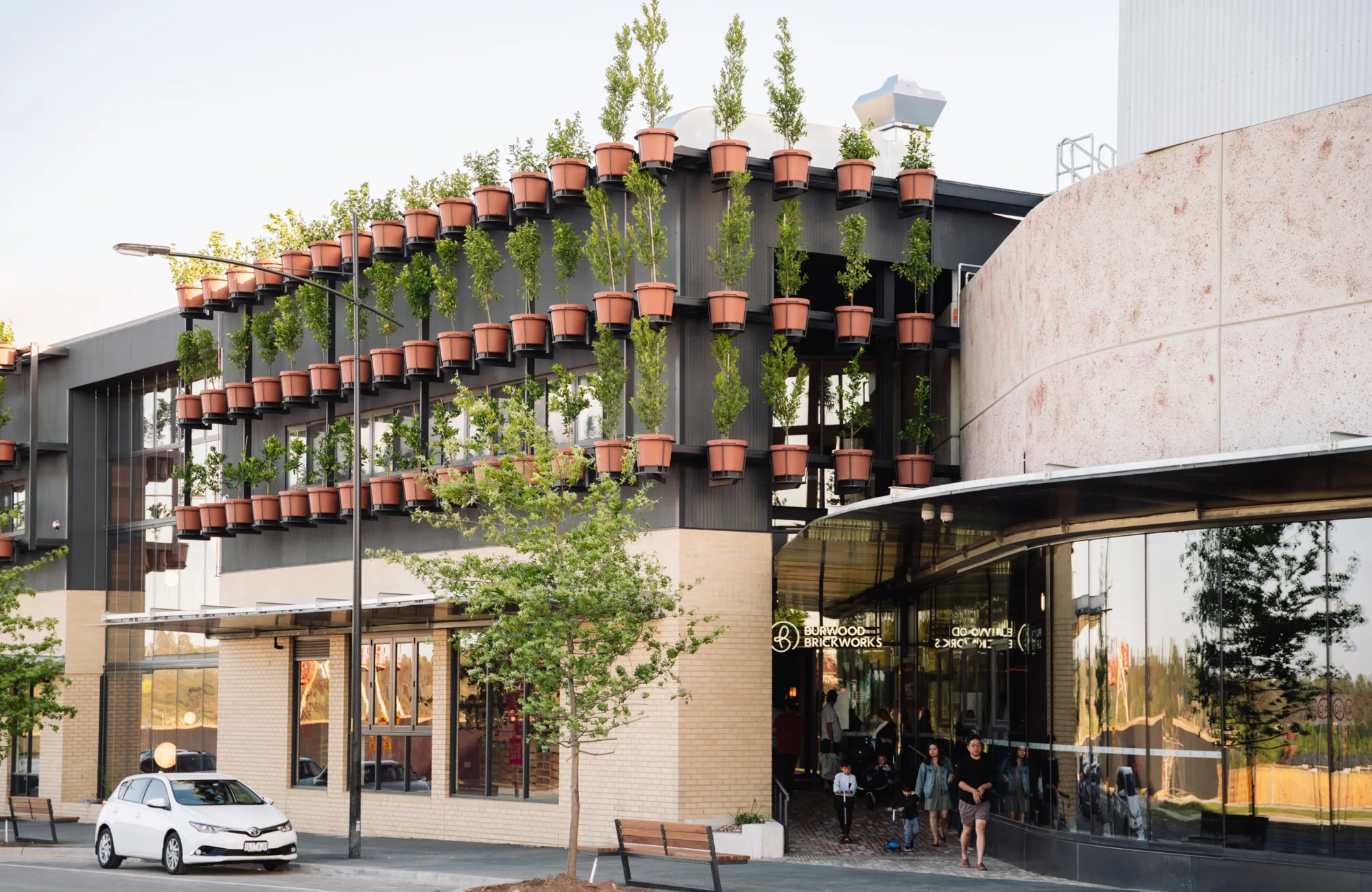 Exterior of Burwood Brickworks shopping Centre with plants in pots mounted to the walls