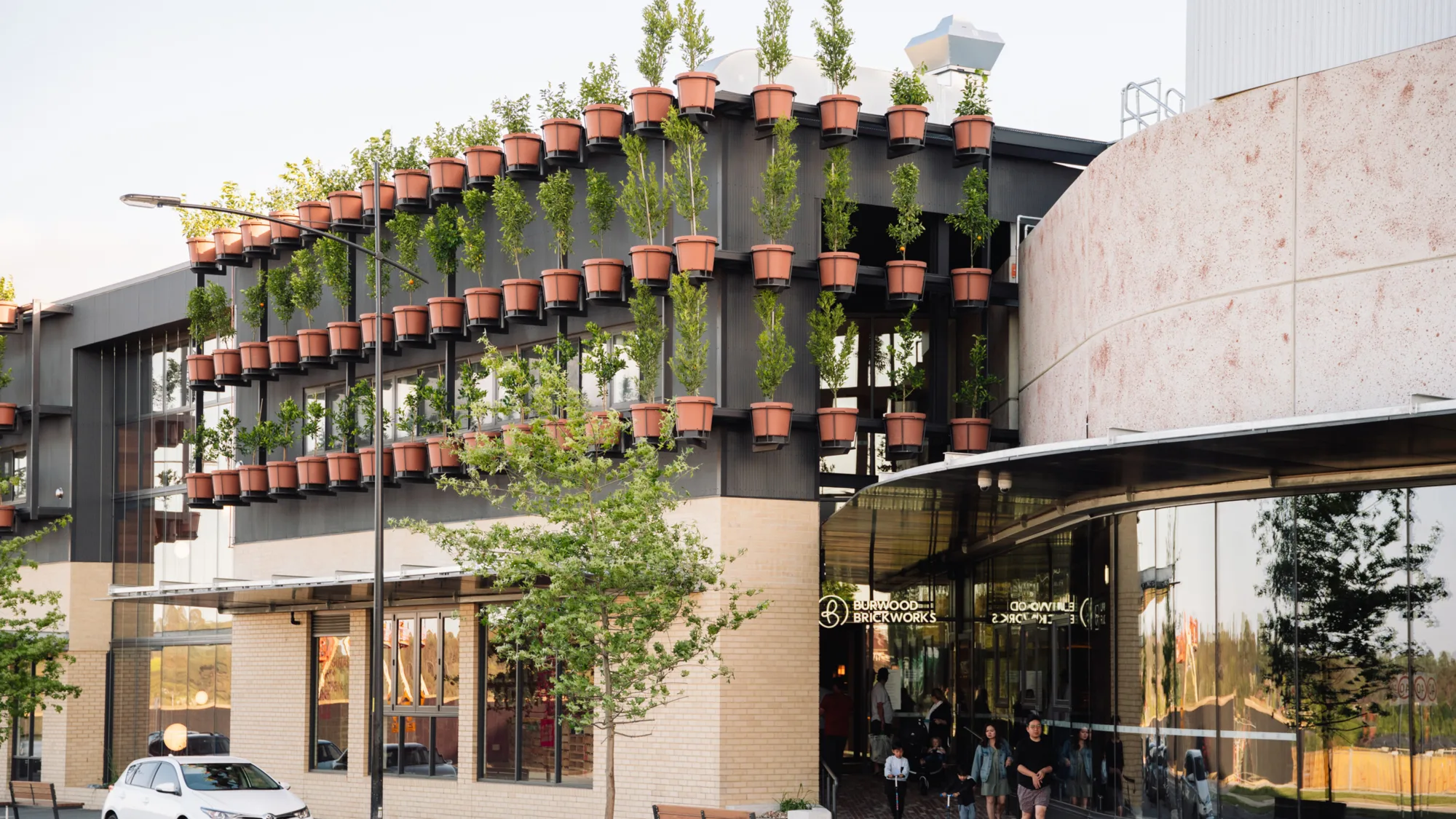 Exterior of Burwood Brickworks shopping Centre with plants in pots mounted to the walls
